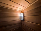 A modern - designed bathroom cedar sauna with a square fir cube shape, heated by an electric furnace.